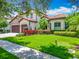 Charming home with a manicured lawn and colorful landscaping, creating a welcoming curb appeal at 9942 Hatton Cir, Orlando, FL 32832