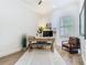 Home office with a modern desk setup, natural light from a window, and a comfortable leather chair at 9942 Hatton Cir, Orlando, FL 32832