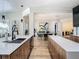 Modern kitchen featuring dual islands, wood cabinets, marble countertops, and a seamless connection to the living space at 9942 Hatton Cir, Orlando, FL 32832