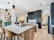 Open kitchen features a marble island, stainless appliances, and modern dark wood cabinetry at 9942 Hatton Cir, Orlando, FL 32832