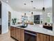 Spacious kitchen with island, modern appliances, wood accents, and seamless flow into the living area at 9942 Hatton Cir, Orlando, FL 32832