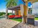 Stylish outdoor lounge area with comfortable seating, a grill, and a pergola, perfect for entertaining at 9942 Hatton Cir, Orlando, FL 32832