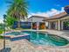 Inviting backyard pool and spa area with a cabana and ample patio space at 9942 Hatton Cir, Orlando, FL 32832