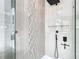 Close up of the frameless shower with gray and white tiles, shower head, and shower niche at 9942 Hatton Cir, Orlando, FL 32832