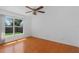 A cozy bedroom features wood-look floors and a sunny window with a view of the backyard at 100 Madden Ave, Sanford, FL 32773
