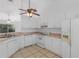 Bright kitchen with white cabinets, and tiled floor, providing a clean and functional space at 100 Madden Ave, Sanford, FL 32773