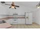 White kitchen with white cabinets and appliances provides a clean, efficient cooking space at 100 Madden Ave, Sanford, FL 32773