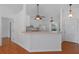 Open-concept living room featuring a breakfast bar connecting to the kitchen, enhancing social interaction at 100 Madden Ave, Sanford, FL 32773