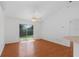 Spacious room with wood-look flooring and sliding glass doors leading to the backyard at 100 Madden Ave, Sanford, FL 32773