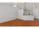 Open-plan living area with wood-look flooring, neutral walls and view into kitchen space at 100 Madden Ave, Sanford, FL 32773