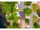 Overhead view of a private residence, pool, and a personal boat house on a lake at 1018 Turner Rd, Winter Park, FL 32789