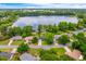 Aerial view of homes nestled on a lake with blue skies and lush green trees at 1018 Turner Rd, Winter Park, FL 32789