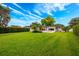 A well manicured back yard with lush green grass and views of the back of the house at 1018 Turner Rd, Winter Park, FL 32789