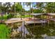 Expansive backyard with boathouse and seating on the water at 1018 Turner Rd, Winter Park, FL 32789