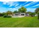 Landscaped backyard features an in-ground pool and mature trees at 1018 Turner Rd, Winter Park, FL 32789