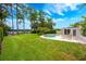 Backyard pool area with a well maintained lawn and access to the lake at 1018 Turner Rd, Winter Park, FL 32789