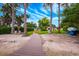 Beautiful backyard with a wooden walkway to the lake with lawn furniture and boats at 1018 Turner Rd, Winter Park, FL 32789