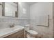 Modern bathroom with marble tile, a sleek vanity, and a convenient toilet location at 1018 Turner Rd, Winter Park, FL 32789