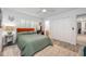 Cozy bedroom with closet and ensuite bathroom, featuring a ceiling fan, closet, and wood look flooring at 1018 Turner Rd, Winter Park, FL 32789