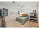 Bright bedroom with modern decor, featuring plantation shutters, stylish art, and a ceiling fan at 1018 Turner Rd, Winter Park, FL 32789