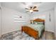 Cozy bedroom features a wood bed frame, neutral walls, light-colored floors, and built-in shelving unit at 1018 Turner Rd, Winter Park, FL 32789
