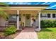 Welcoming front porch with lovely décor and well-maintained brick walkway at 1018 Turner Rd, Winter Park, FL 32789