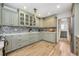 Stylish kitchen with sage cabinets, modern appliances, and tile backsplash at 1018 Turner Rd, Winter Park, FL 32789