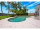 The pool with decorative waterfall feature is nestled among mature trees and palms at 1018 Turner Rd, Winter Park, FL 32789