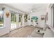 Inviting sunroom with french doors leading to the backyard, featuring comfortable seating and stylish decor at 1018 Turner Rd, Winter Park, FL 32789
