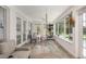 Cozy sunroom with comfortable seating, large windows, and a view of the pool and backyard at 1018 Turner Rd, Winter Park, FL 32789