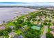 Aerial view of neighborhood waterfront homes, tennis courts, and community with lakeside access at 10241 Pointview Ct, Orlando, FL 32836