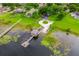 Waterfront property with private dock and boat lift boasts lush landscaping and serene lake views from an aerial perspective at 10241 Pointview Ct, Orlando, FL 32836