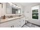 Modern bathroom with granite countertops, double sinks, and decorative mirrors and lighting at 10241 Pointview Ct, Orlando, FL 32836