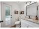 Charming bathroom featuring granite counters, an undermount sink, and a textured glass door to the outdoor space at 10241 Pointview Ct, Orlando, FL 32836