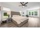 Spacious bedroom with a neutral color palette, many windows, and modern ceiling fan at 10241 Pointview Ct, Orlando, FL 32836