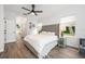 Stylish bedroom with hardwood floors, gray headboard, and plenty of natural light at 10241 Pointview Ct, Orlando, FL 32836