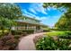 Community clubhouse with a wraparound porch, lush landscaping and convenient walking path at 10241 Pointview Ct, Orlando, FL 32836