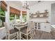 Elegant dining area with wooden table, stylish chairs, decorative shelves, and lots of natural light from the nearby windows at 10241 Pointview Ct, Orlando, FL 32836