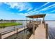 Community dock on the lake, featuring a covered gazebo with picnic tables and bench seating at 10241 Pointview Ct, Orlando, FL 32836