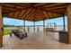 Covered gazebo on the lake dock offering comfortable seating and scenic views at 10241 Pointview Ct, Orlando, FL 32836