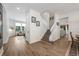 Open-concept hallway showcasing stairway, living room and a seamless transition between rooms with modern flooring at 10241 Pointview Ct, Orlando, FL 32836
