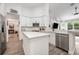Open concept kitchen with stainless appliances, island and view to living room at 10241 Pointview Ct, Orlando, FL 32836