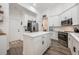 Bright, white kitchen with stainless steel appliances, island, and modern finishes at 10241 Pointview Ct, Orlando, FL 32836