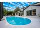 Sparkling screened-in pool features inviting lounge area and ample space for outdoor entertaining in the Florida sunshine at 10241 Pointview Ct, Orlando, FL 32836