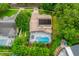 Aerial view of backyard pool with screened enclosure and solar panels on roof at 10241 Pointview Ct, Orlando, FL 32836