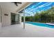 Inviting screened-in pool area with a white deck, serene blue water, and lush green landscaping at 10241 Pointview Ct, Orlando, FL 32836