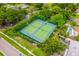 Aerial view of community tennis courts, surrounded by lush greenery and neighborhood homes at 10241 Pointview Ct, Orlando, FL 32836