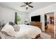 Bright bedroom with a large window, ceiling fan, and a wooden dresser under a TV at 1027 Eagle Tree Ln, Sanford, FL 32771