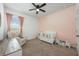 Cozy Bedroom featuring a crib, a comfortable chair, and soft, pastel colors, creating a soothing environment at 1027 Eagle Tree Ln, Sanford, FL 32771