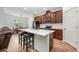 Well-lit kitchen featuring a center island, stainless steel appliances, and dark wood cabinets with modern fixtures at 1027 Eagle Tree Ln, Sanford, FL 32771